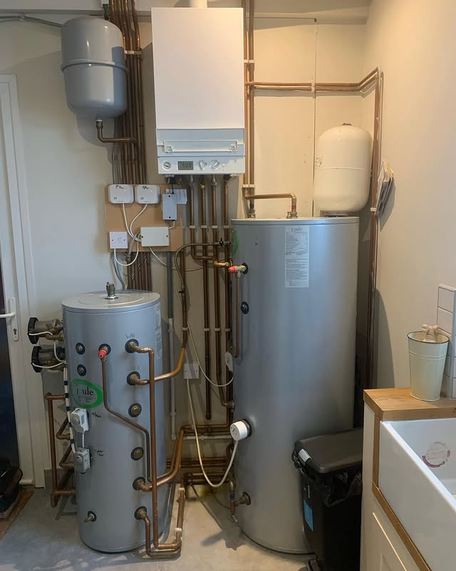 Multi-fuel heating plant room with boiler and twin cylinders